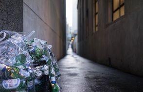 narrow city street with garbage