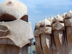 sculptures in barcelona against blue sky
