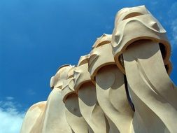 totem poles against a blue sky