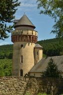 medieval Tower behind stone wall at forest, germany