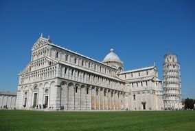 leaning tower behind the building in tuscany