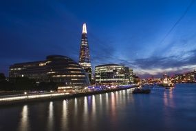 London city buildings near the river at night