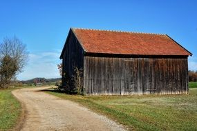 Beautiful wood house on the field near the plants