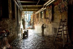 workers clean bricks in an arch