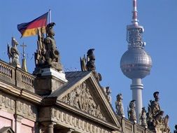 Berlin TV tower and the roof of the government with the flag