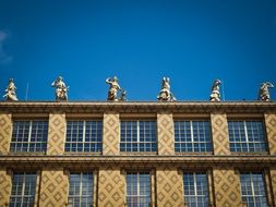 female Figures at top of building