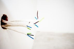 white wires stick out of the wall