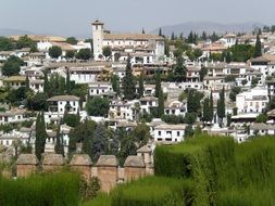 beautigul cityscape with old white buildings and tower, spain, granada