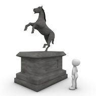 man stands near a monument with a horse