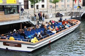 people in a boat on copenhagen canal