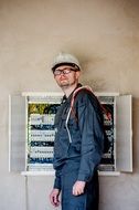 electrician man near the electrical panel with wires