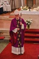 priest in a cassock in the church