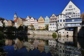 architecture of the old city is reflected in the water in Tuebingen