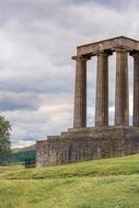 national monument of scotland on a green hill