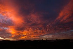 dramatic red Clouds at sunset sky, south africa, cape town