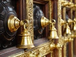 macro photo of golden bells in hindu temple