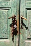 rusty chain and lock on an old entrance door