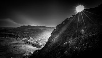 black and white photo sun over edinburgh