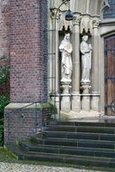 two angel figures at the entrance to the church