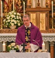 praying bishop in the church