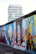 side view of the berlin wall in bright graffiti
