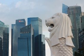 Merlion, fish lion statue against the background of skyscrapers in Singapore