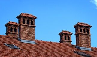 four brick chimneys on the roof