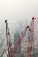 tops of the construction cranes