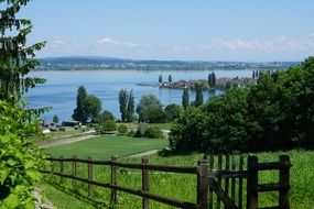 wooden fence near a green field with trees, thurgau