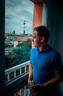 a man stands on the balcony
