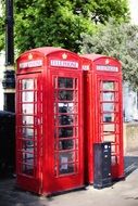 two red telephone booths on the streets of london