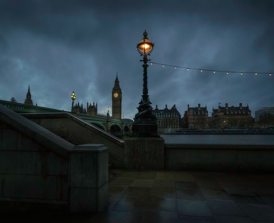 view of the night promenade near big ben in london