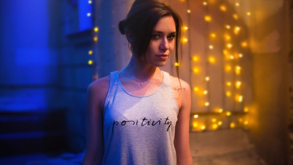 girl in a vest among the colorful night lights