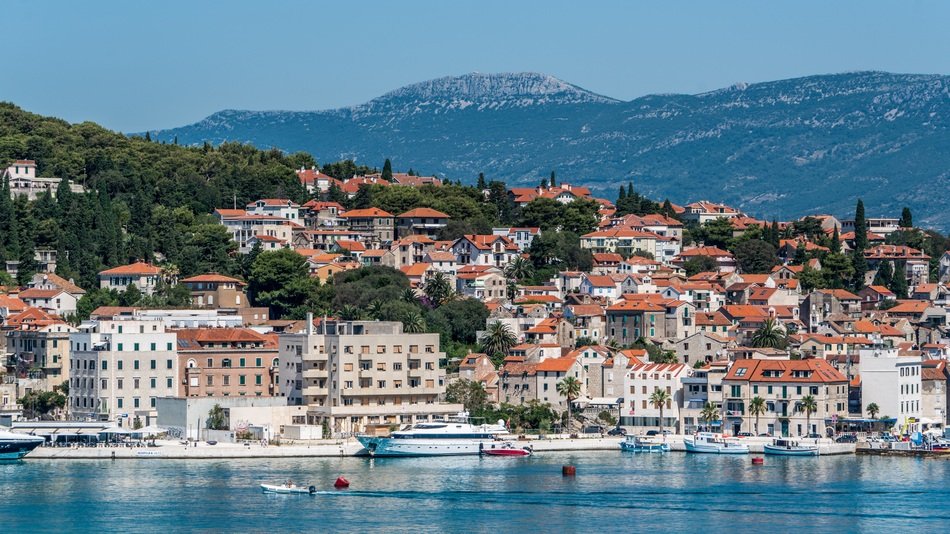 a city on the coast on the background of mountains