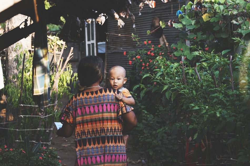 mom holding a baby in Asia