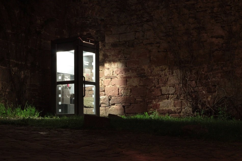 telephone booth light in the dark