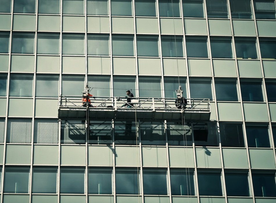 window washers on the facade of the building