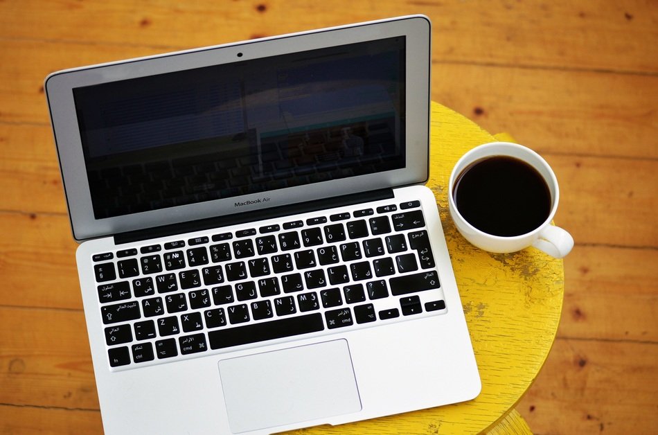 laptop and cup of coffee on the table