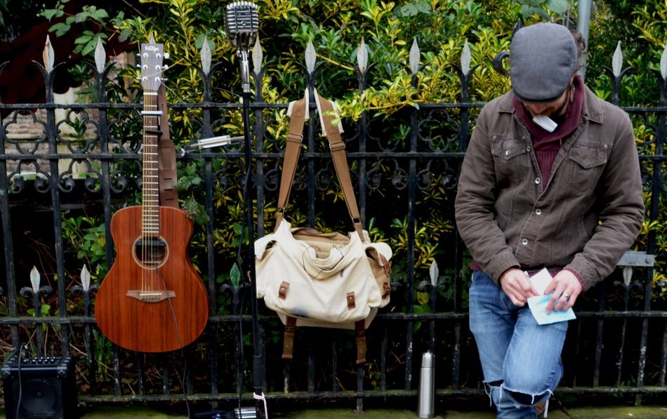 street musician near the metal fence