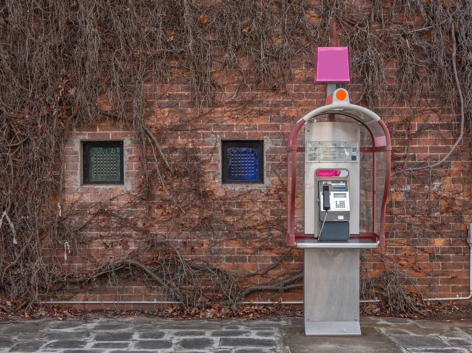payphone on brick wall background