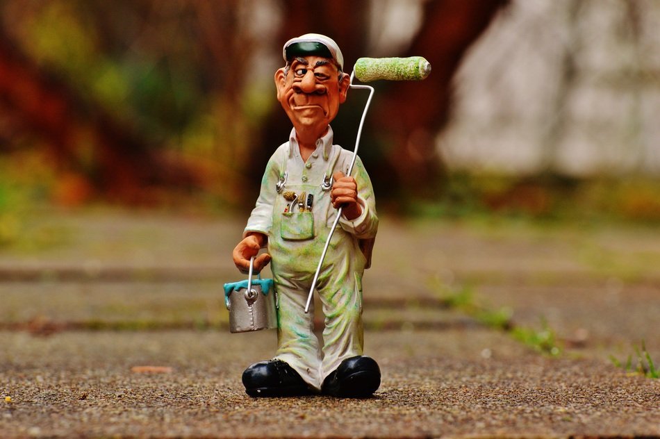 ceramic figurine in the form of an artist on the asphalt path