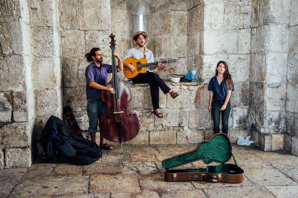 street musicians near a building in israel