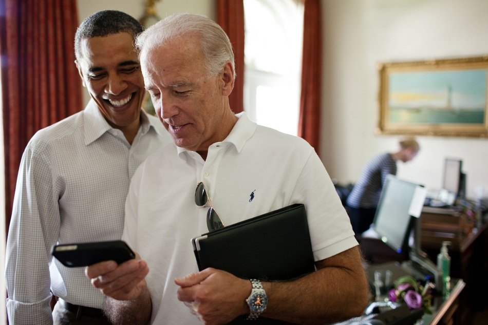 Barack Obama looking at Iphone