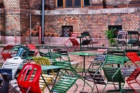 multi-colored chairs and tables in an outdoor cafe