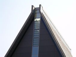 triangular gable roof of modern building at sky