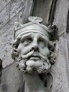 statue of a man's head on a building wall