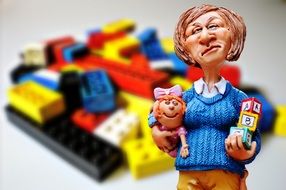 children's teacher figurine on the background of toys