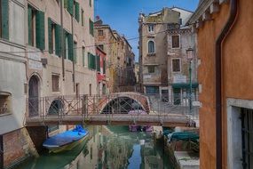 bridge over a canal between streets in venice