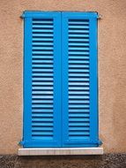 closed blue shutters on the wall close up