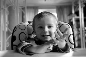 black and white portrait of a child at the table